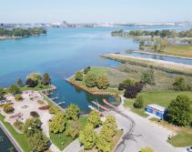 waterfront walkway with flowers and pedestrians enjoying the path